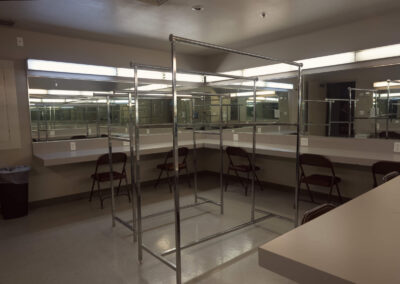 Dressing Room with costume racks with makeup mirrors and counter space all around